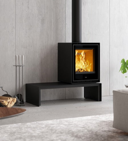 Clare ADF Clare 60S Vt B freestanding wood fireplace with a modern design and a glass front for viewing the fire.