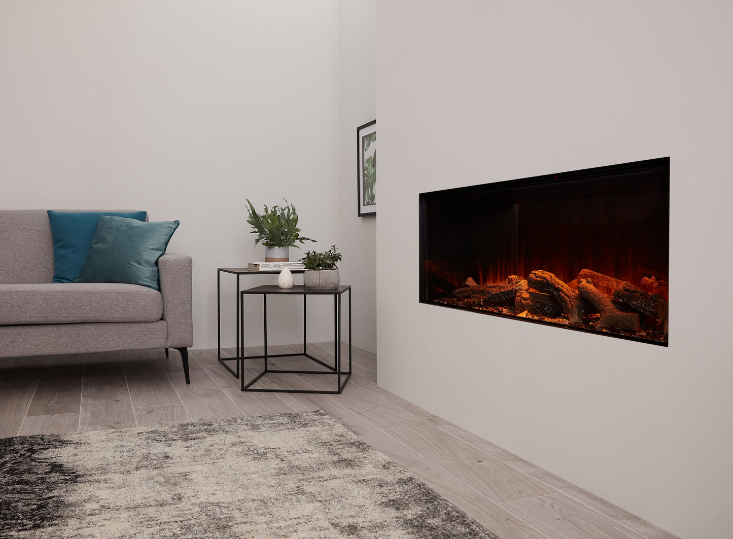 Electric fireplace by British Fires, New Forest 1200 model, featuring a modern design with a realistic fire display in a cozy living room setting.