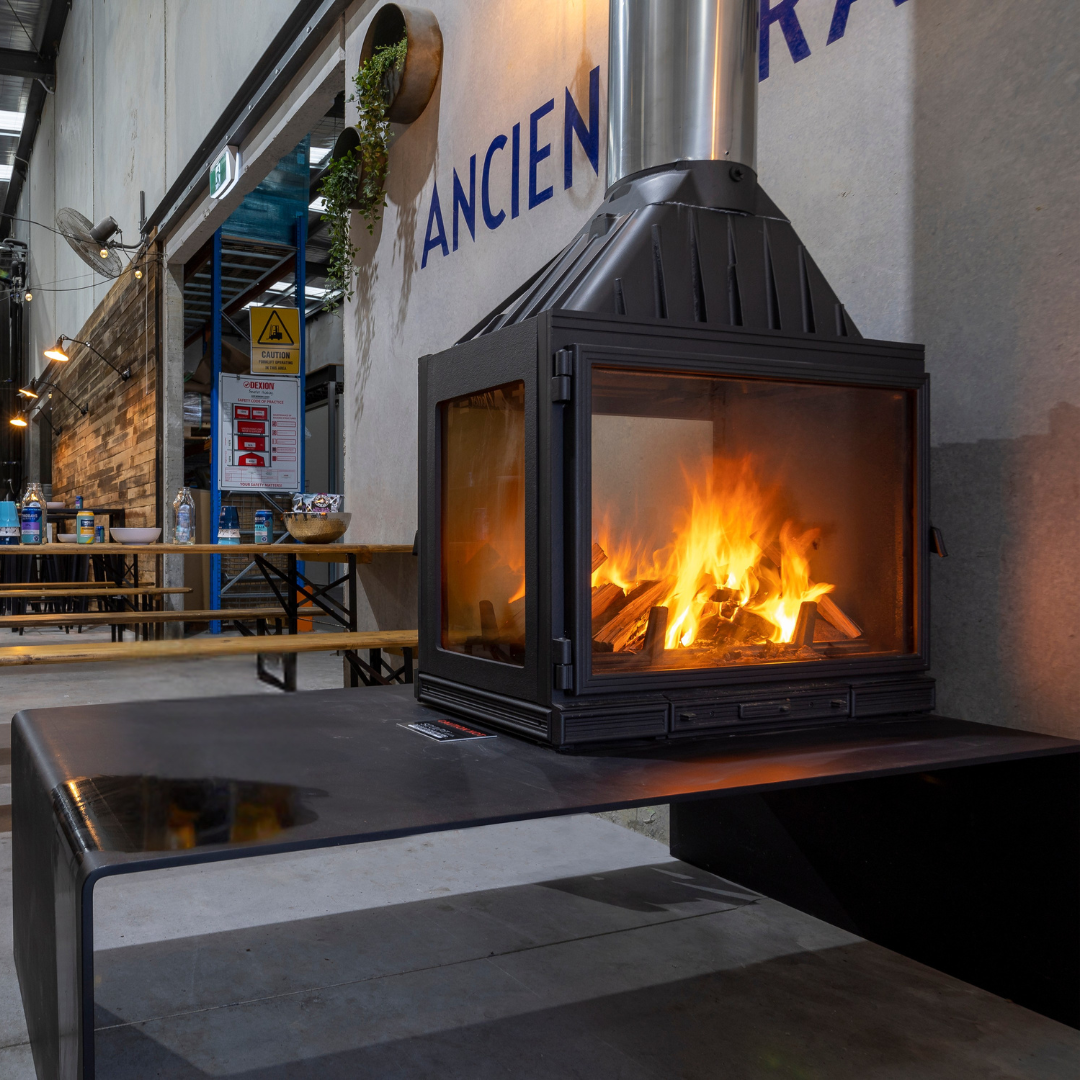 Seguin MultiVision 8000 wood fireplace with three-sided glass design, showcasing a modern, single-side glass view of the fire.