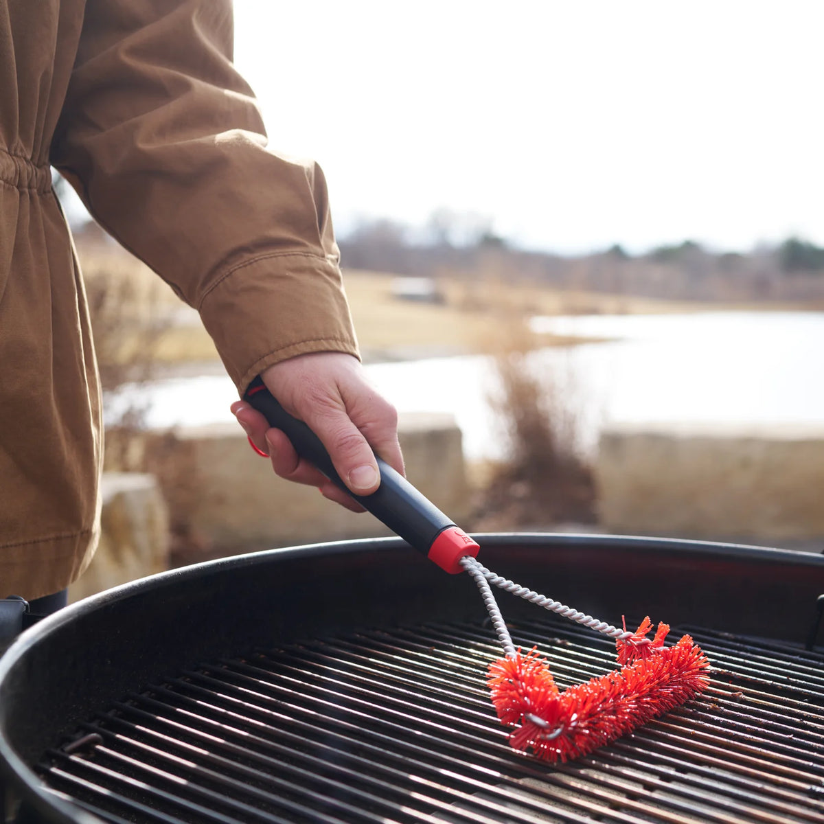Small Weber Cold Cleaning Grill Brush for BBQ and fireplace grill maintenance, featuring sturdy bristles and a comfortable handle.