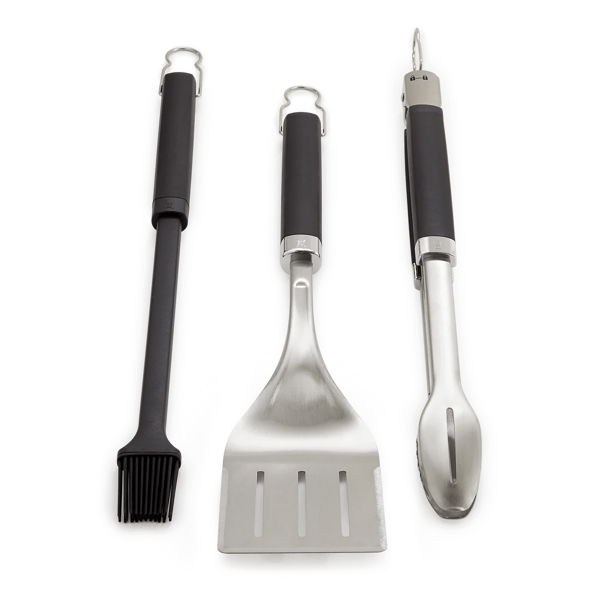 Weber 3-piece utensil set with tongs, spatula, and basting brush for grilling and cooking, shown on a white background.
