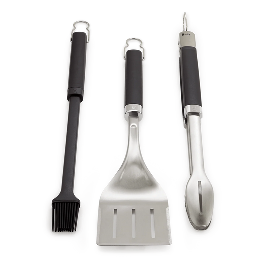 Weber 3-piece utensil set with tongs, spatula, and basting brush for grilling and cooking, shown on a white background.