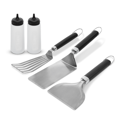 Weber Griddle Essentials Set of cooking utensils and tools for griddle cooking, including spatula, tongs, and scraper.