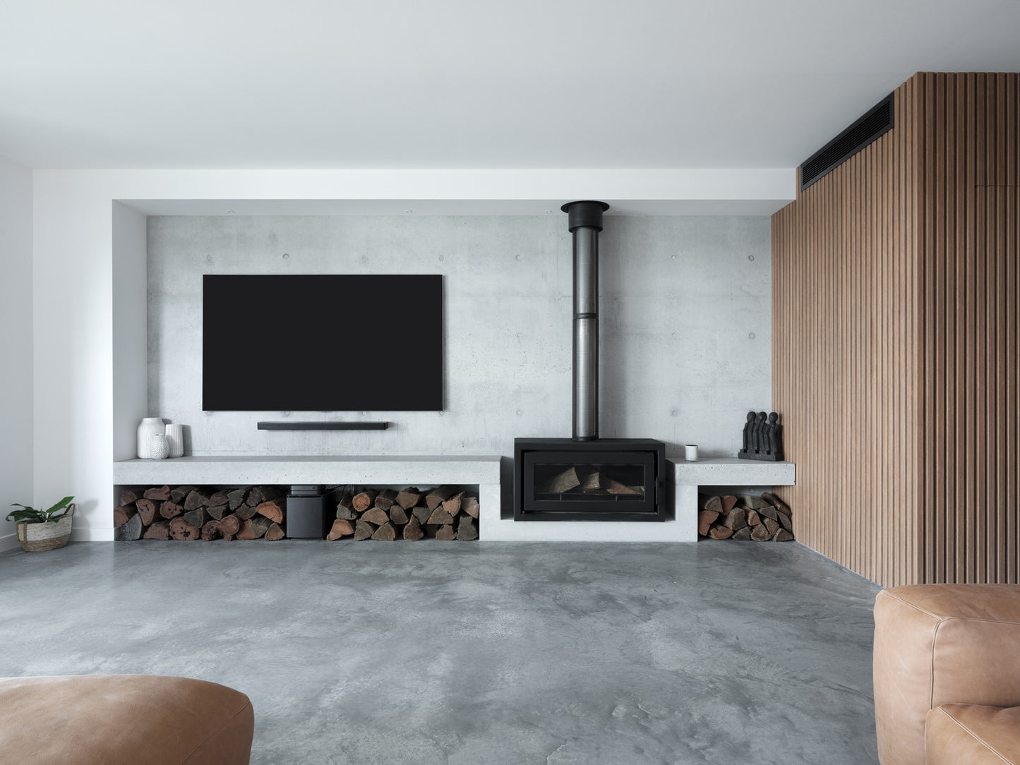 Kemlan CELESTIAL 900 Freestander wood fireplace with fixed handle, modern design, showcasing the front view of the fireplace in a home setting.