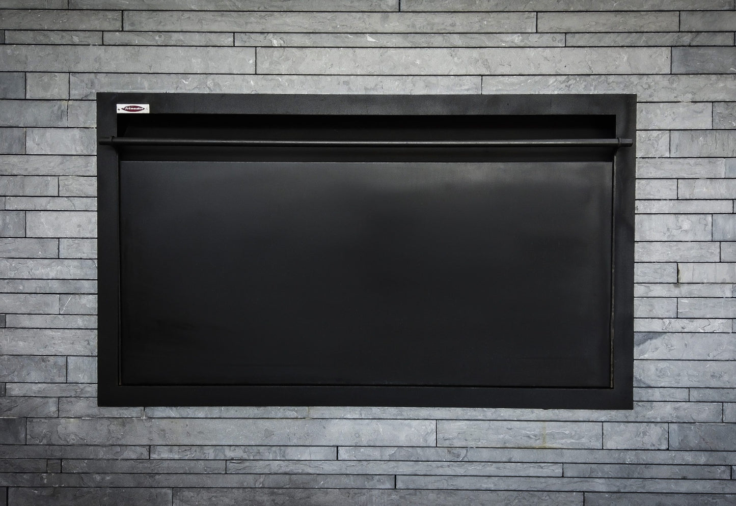 Jetmaster Horizon 1200 built-in wood fireplace with closed BBQ lid, showcasing sleek black exterior and modern design.