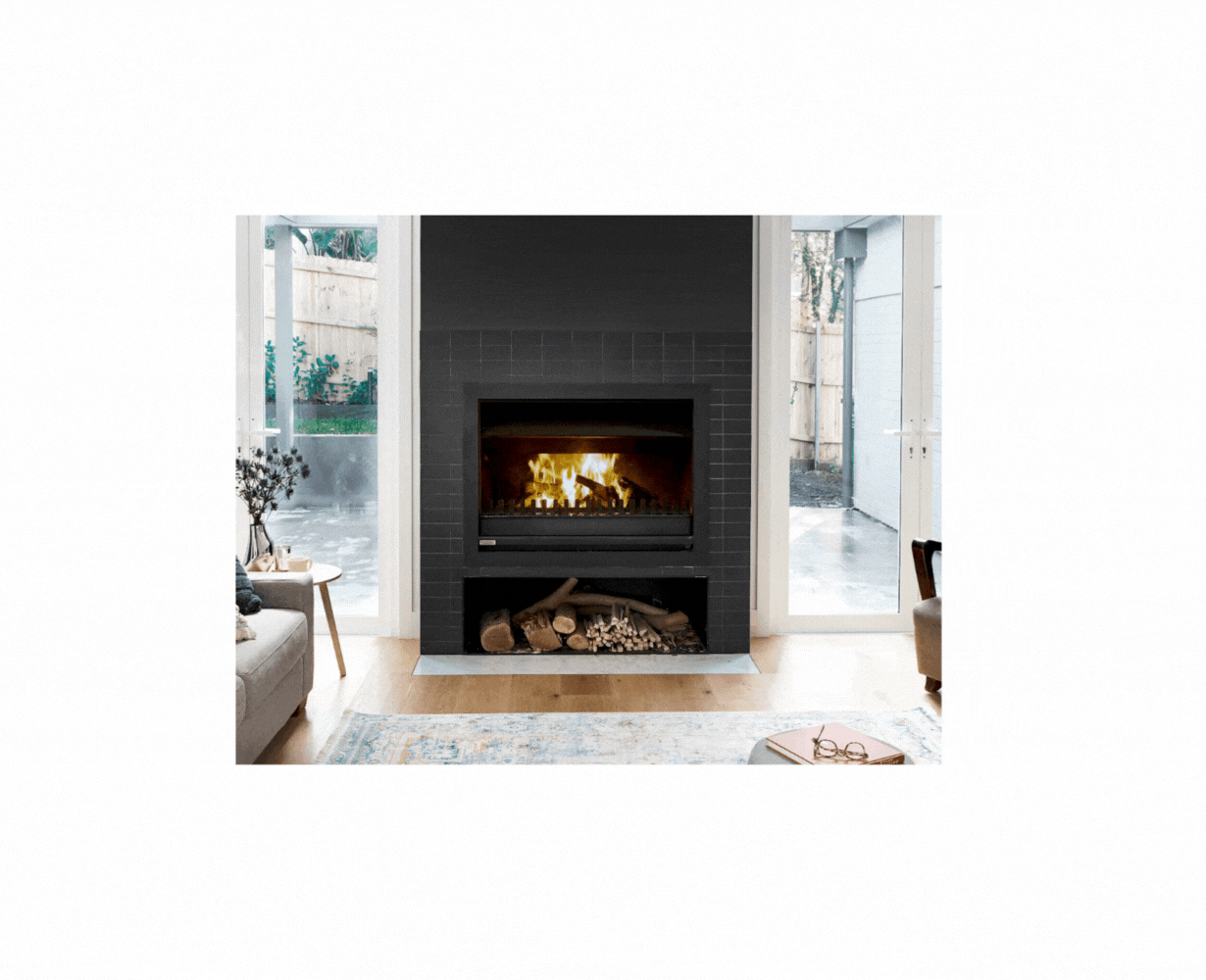 Jetmaster 700SH wood fireplace with included instructions, showing the firebox and installation components.