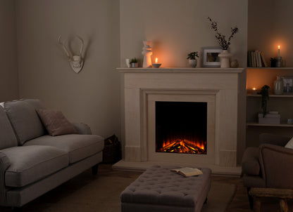 British Fires New Forest 650 SQ Deluxe electric fireplace with realistic log display in a cozy living room setting