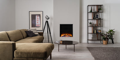 Electric fireplace by British Fires featuring a realistic New Forest 650 sq deluxe log set in a cozy room setting.