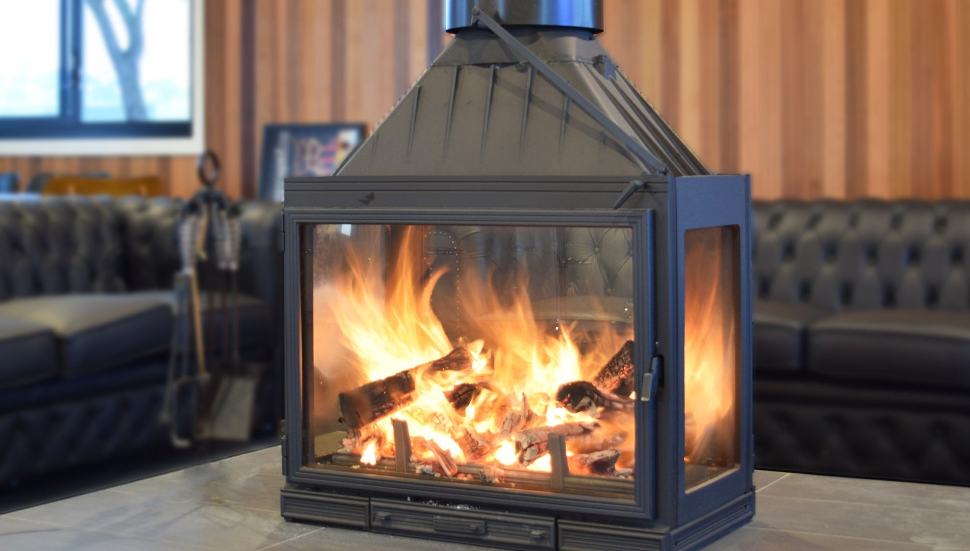 Seguin MultiVision 8000 4-sided wood fireplace showing modern design with glass panels and interior fire chamber.