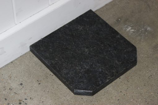 Haus Fire black granite flat wall hearth with tapered edges, 1050x1050x20mm, designed for fireplace accessories.