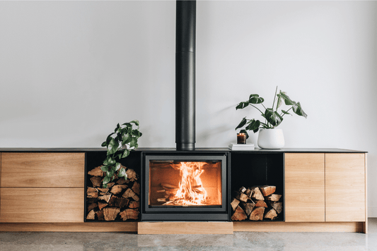 Stuv 16-78 Cube wood fireplace with sleek black exterior and glass door, showcasing modern design and interior fire chamber.