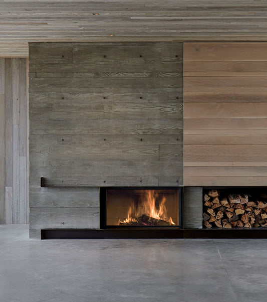 Stuv 21 wood fireplace with slow combustion feature, showcasing a modern design and open front with fire inside.