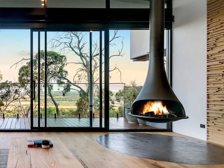 Bordelet Tatiana 997 central rotating wood fireplace in grey with a modern, sleek design and a central rotating firebox feature.