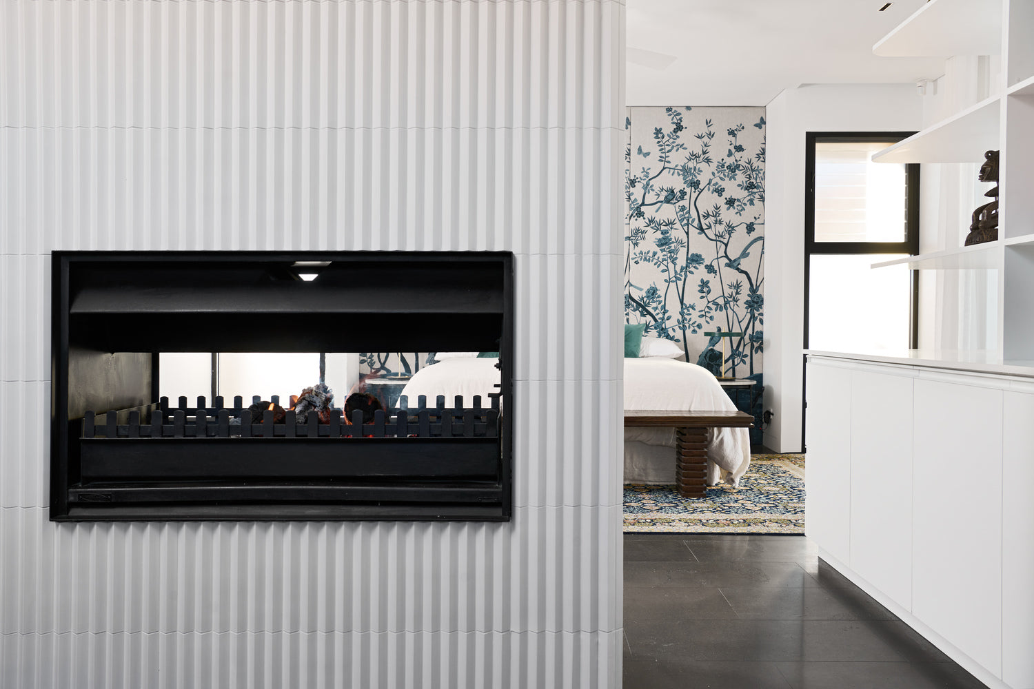 Jetmaster double-sided wood fireplace with instruction manual, featuring sleek design and viewing windows for both sides.
