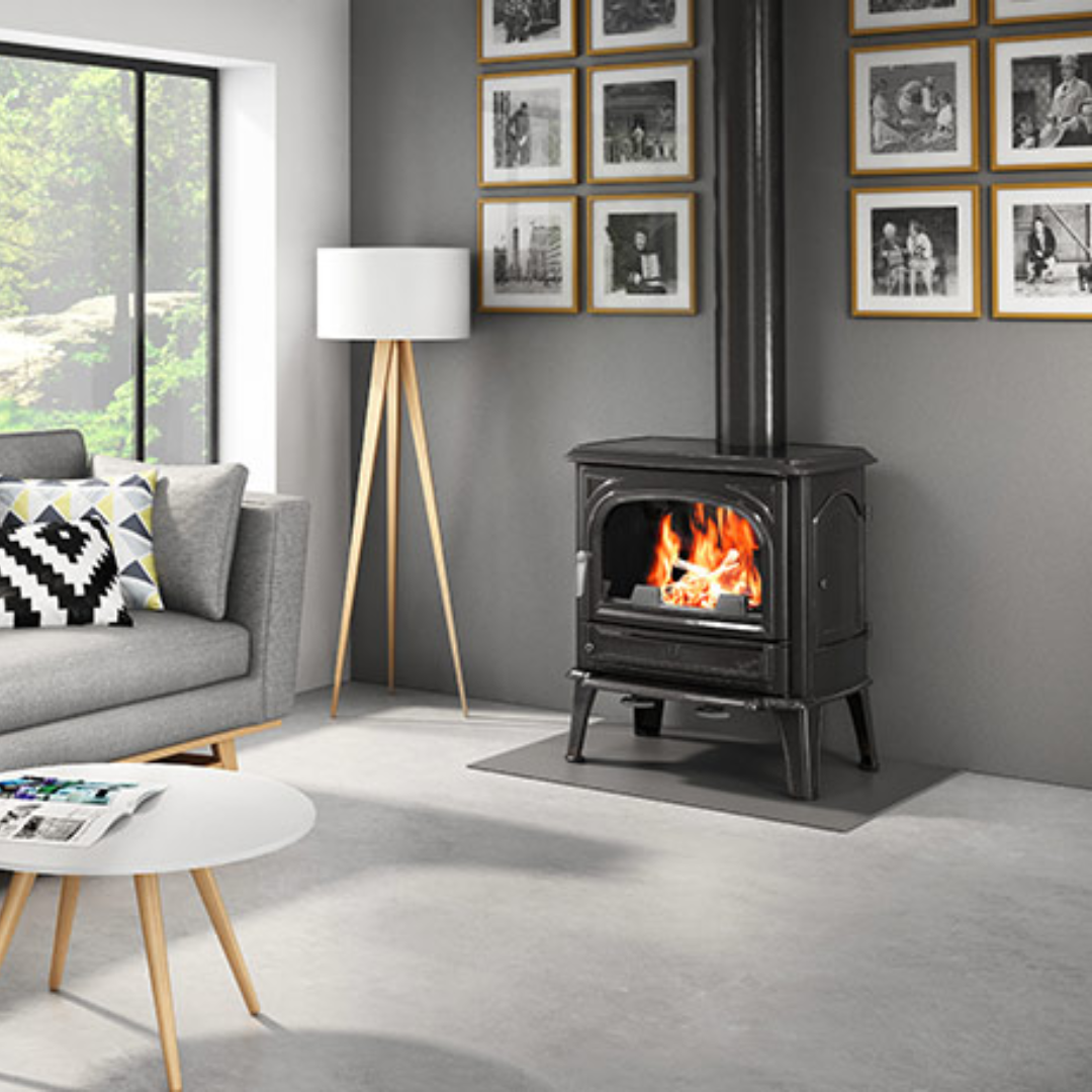 Seguin Saphir freestanding grey wood stove with glass door and metal handle, designed for efficient home heating and cozy ambiance.