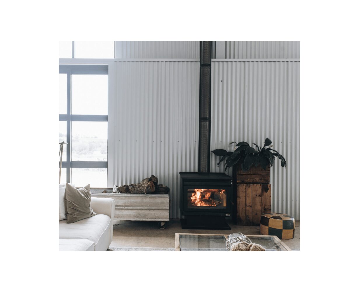 Kemlan XL freestanding wood fireplace in black with built-in fan for efficient heating and sleek modern design.